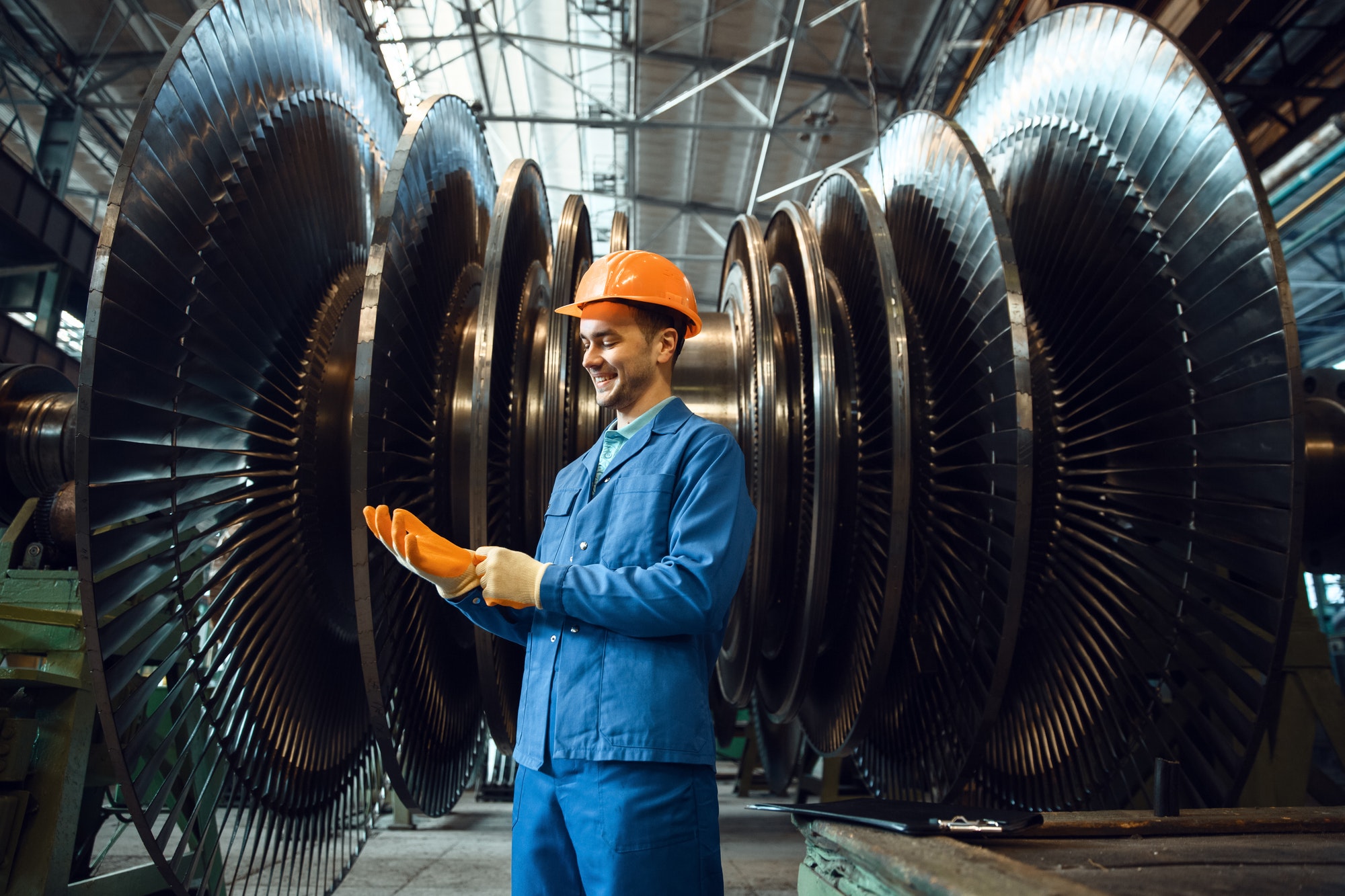 worker-checks-turbine-impeller-vanes-on-factory